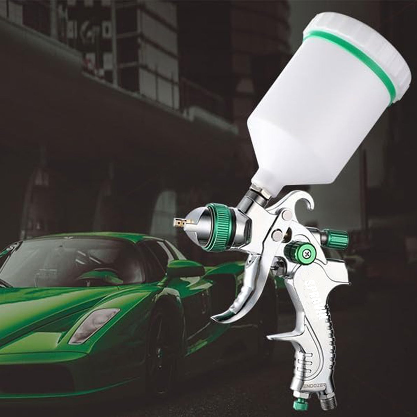 Spray gun with green accents in front of a green car