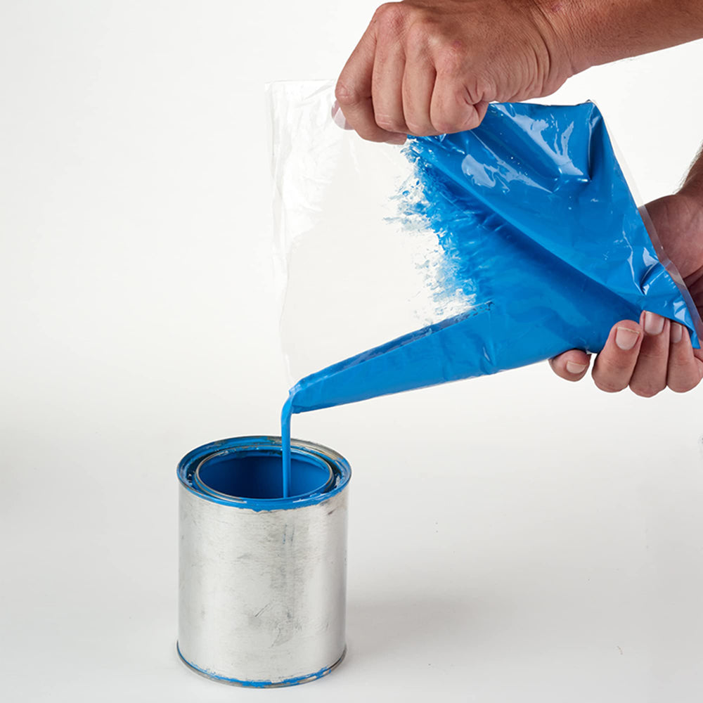 Person using a blue funnel to pour paint from a plastic bag into a metal can