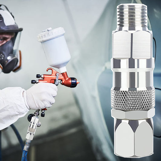 Close-up of a spray gun nozzle with a person using a spray gun in the background.